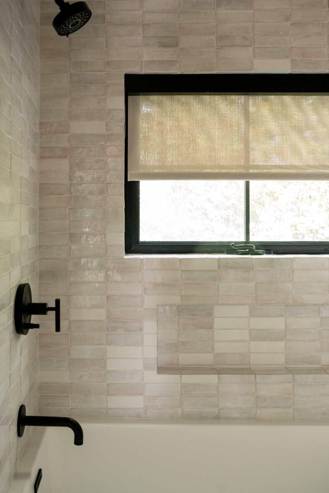 Custom roller shade installation in a tiled bathroom