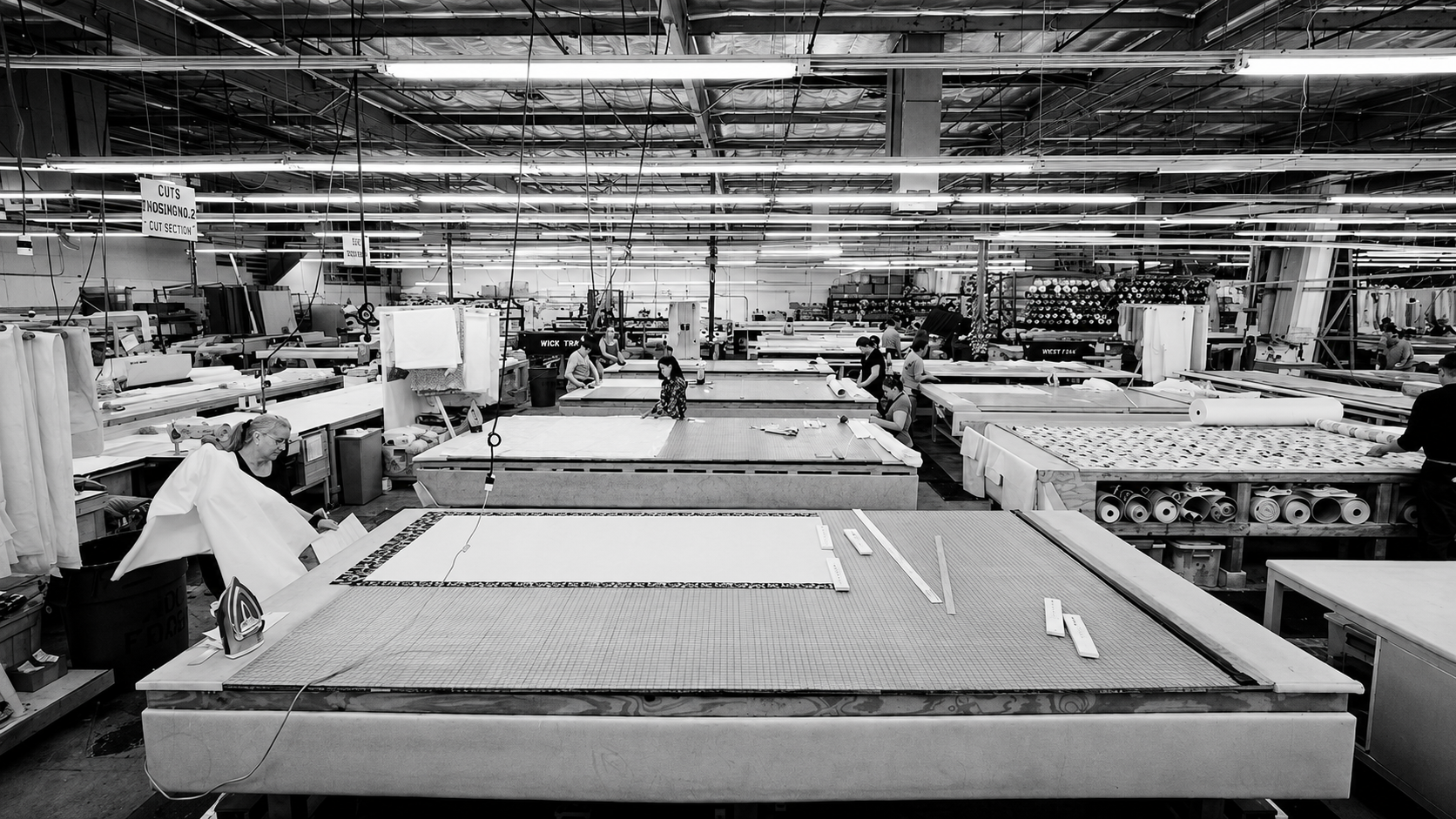 Fabrication tables and craftspeople inside the Fabritec workroom